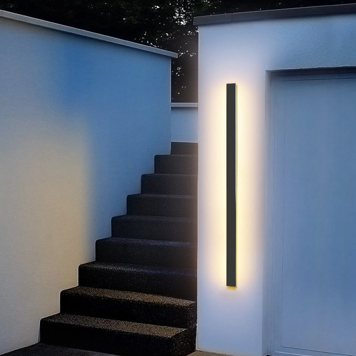 Sleek LED outdoor wall sconce, weatherproof for exterior facade lighting. Energy-efficient modern home decor.
