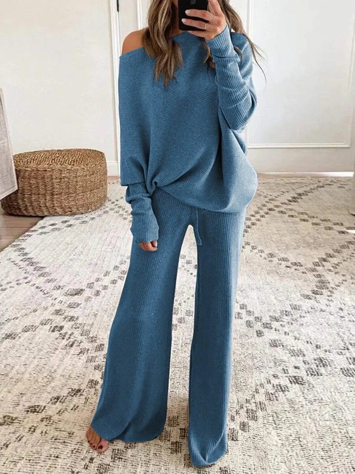 Modern blue women's two-piece off-shoulder top & wide-leg trousers lounge set, ideal for relaxed style.
