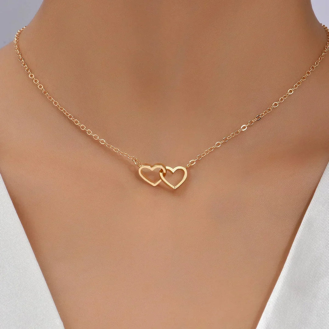 Women's gold vermeil interlocking heart pendant necklace, sterling silver chain, delicate and elegant heart jewelry.