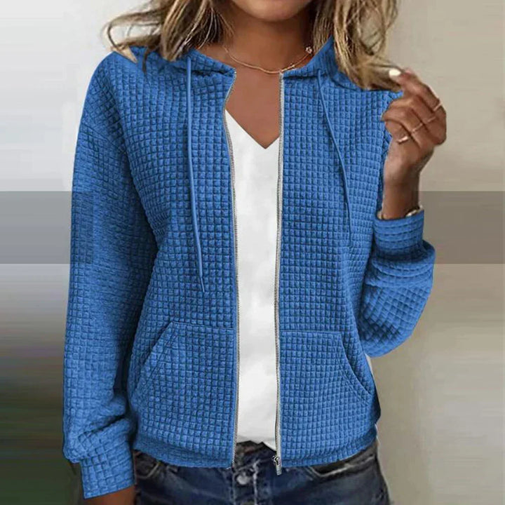 Women's warm checked water-resistant jacket, a stylish layering piece for winter fashion and outdoor comfort.