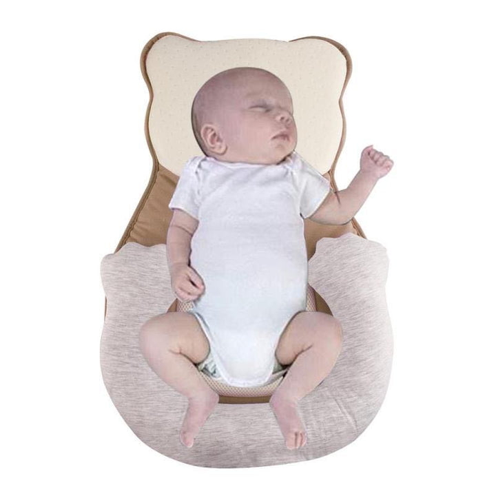 Ergonomic newborn baby lounger pillow with adjustable leg support, providing essential infant positioning.
