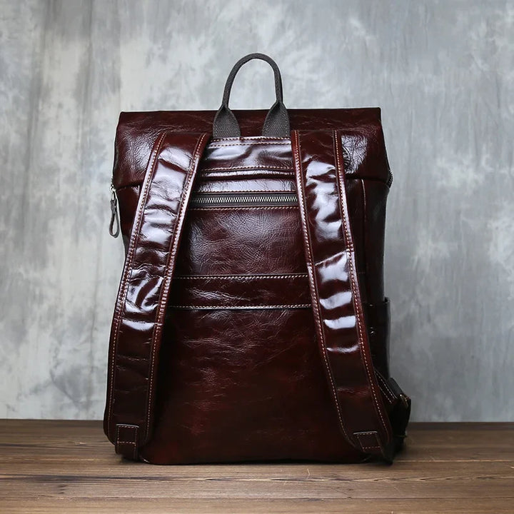 Men's large capacity vegetable-tanned cowhide leather laptop backpack for business travel and daily commute.