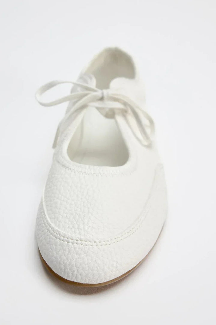 Dressy women's lace-up ballet flats in sophisticated maroon, combining fashion with comfort.