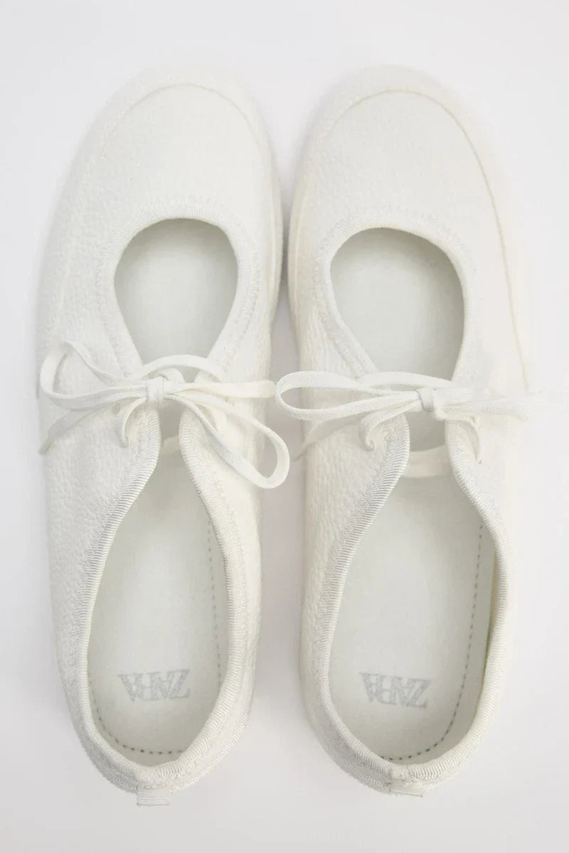 Side profile of women's everyday lace-up ballet flats, highlighting the flexible sole for comfort.