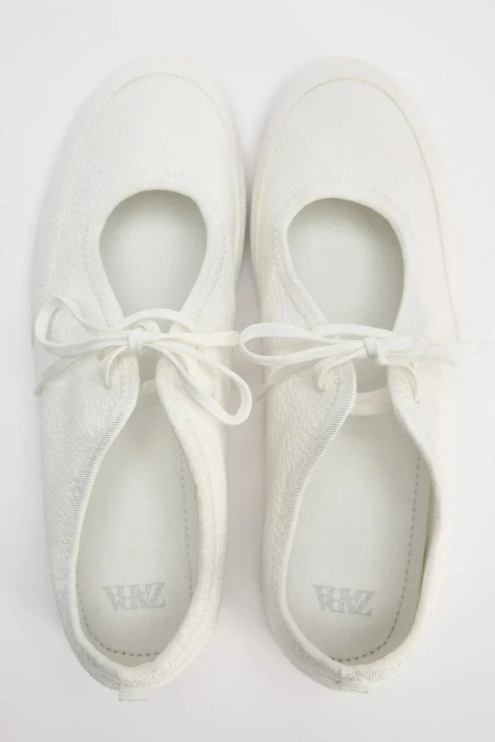 Side profile of women's everyday lace-up ballet flats, highlighting the flexible sole for comfort.
