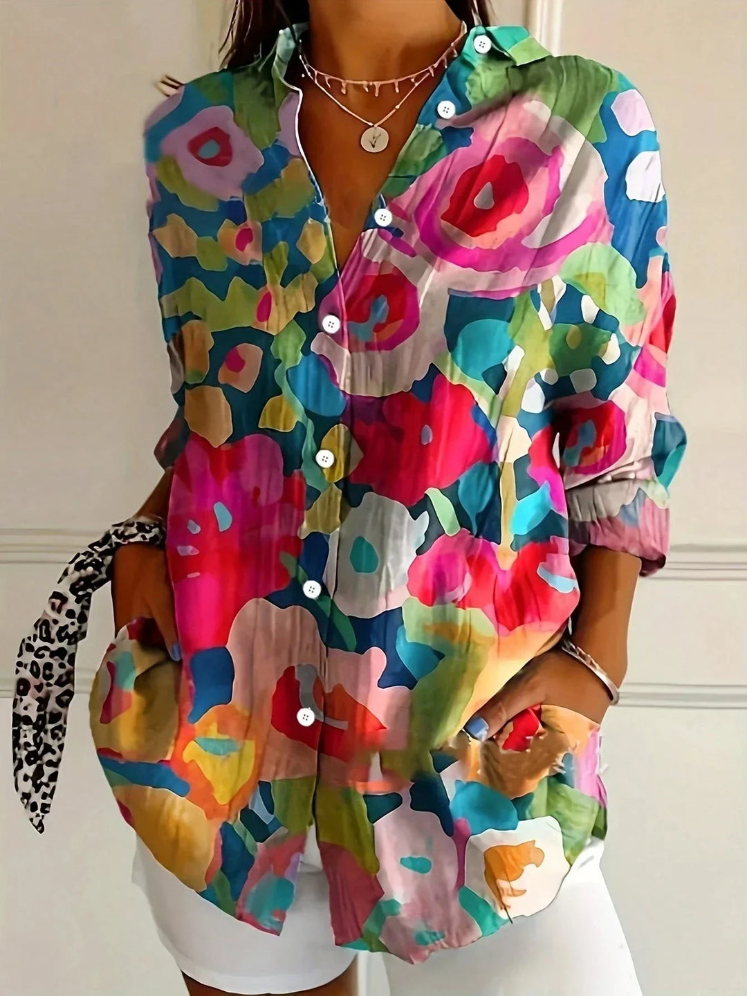 Comfortable women's abstract print blouse. Button-front, long sleeve top with a unique vibrant pattern.