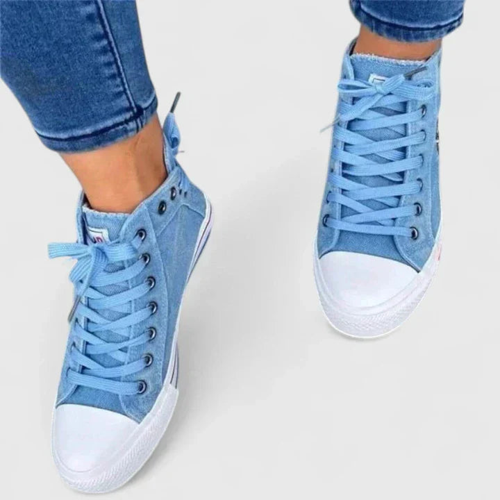 Casual women's footwear: High-top denim sneakers with unique zip and stud accents, blending comfort and style.