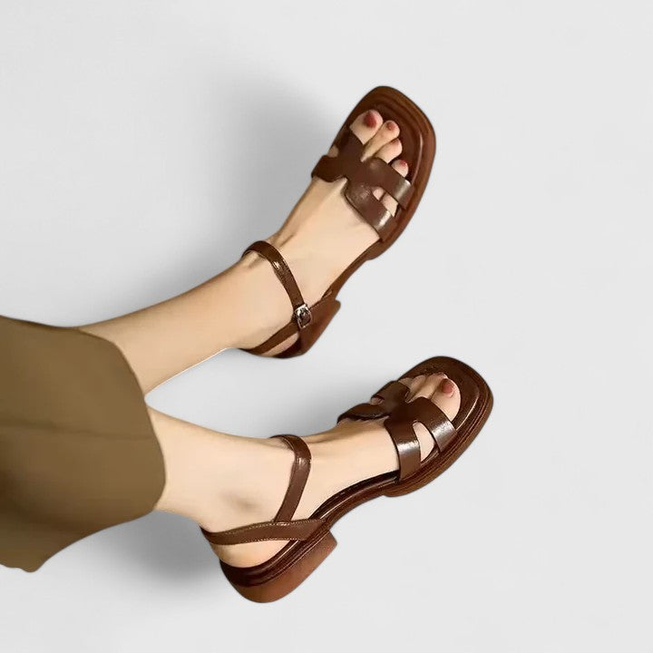 Comfortable women's versatile flat sandals featuring a low block heel, ideal for elegant summer outfits.