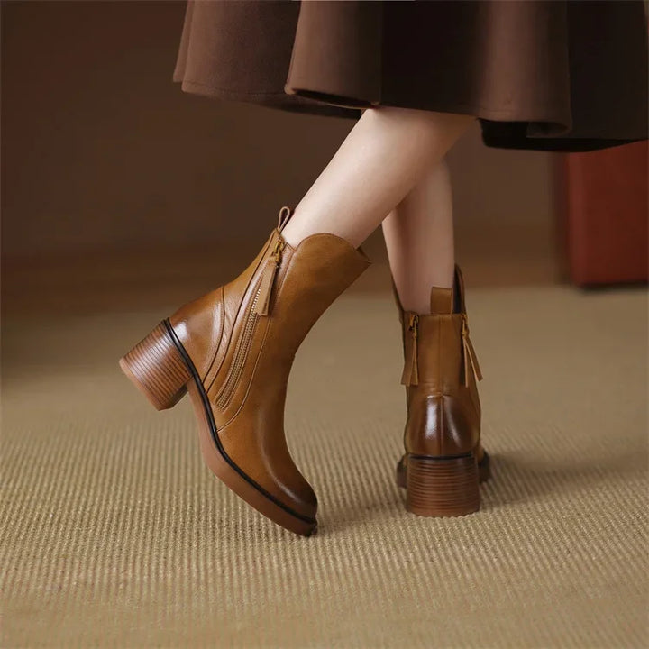 Elegant women's ankle boots featuring a comfortable platform heel and convenient zip, combining style & stability.