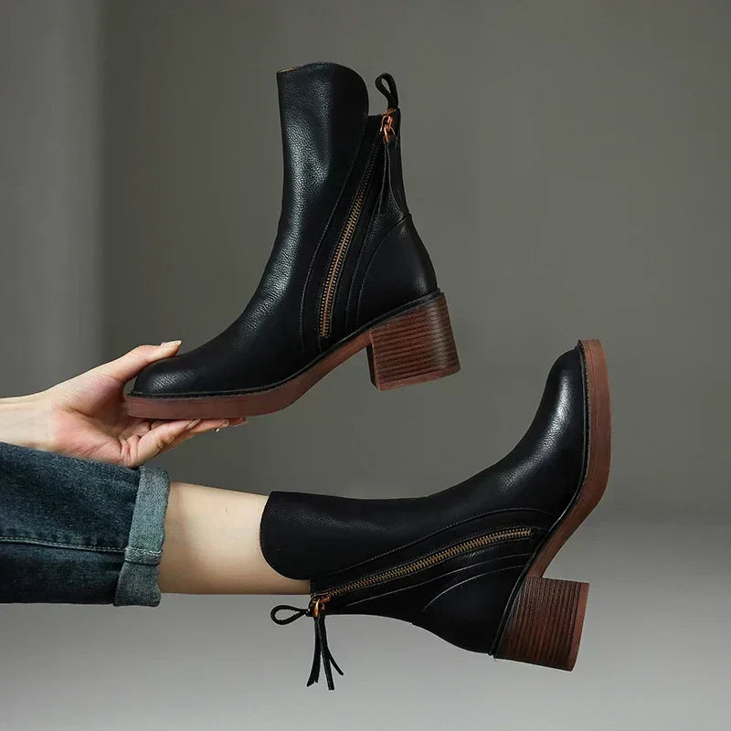 Women's elegant black zip ankle boots with comfortable platform heel, perfect for fall fashion & winter chic.