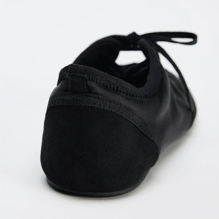 Comfortable women's walking ballet flats with supportive lace-up design, great for daily use.