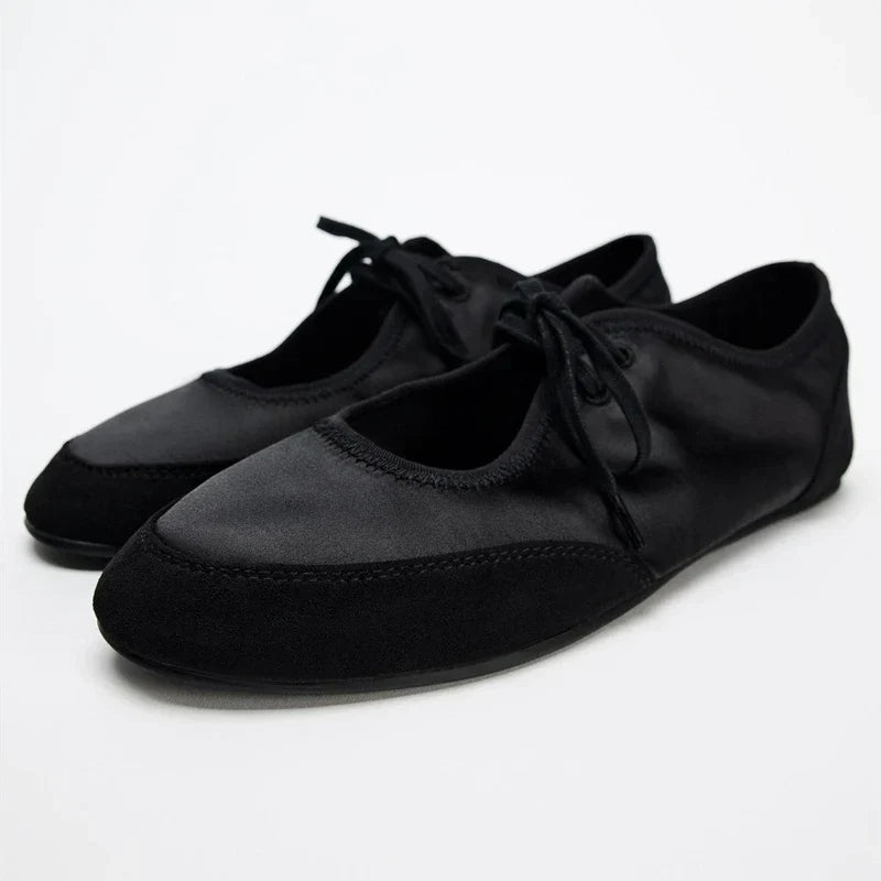 Versatile women's black lace-up ballet flats, providing supreme comfort and effortless style.