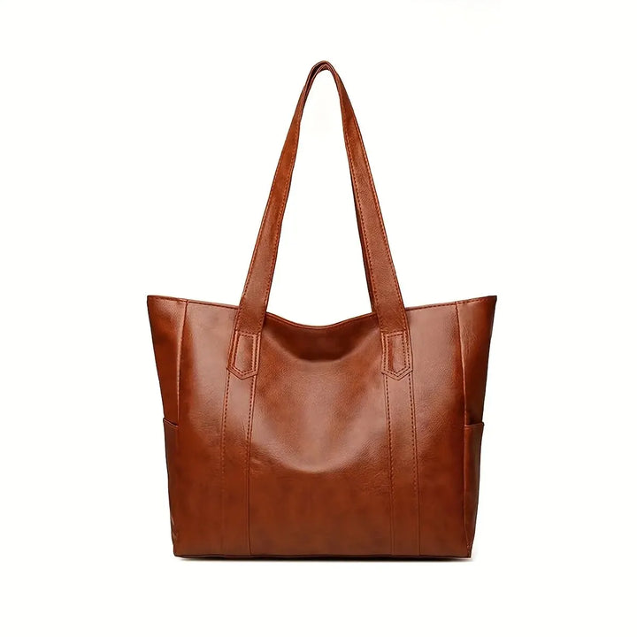 Close-up of a sophisticated genuine leather crossbody bag with detailing, an elegant women's shoulder bag.