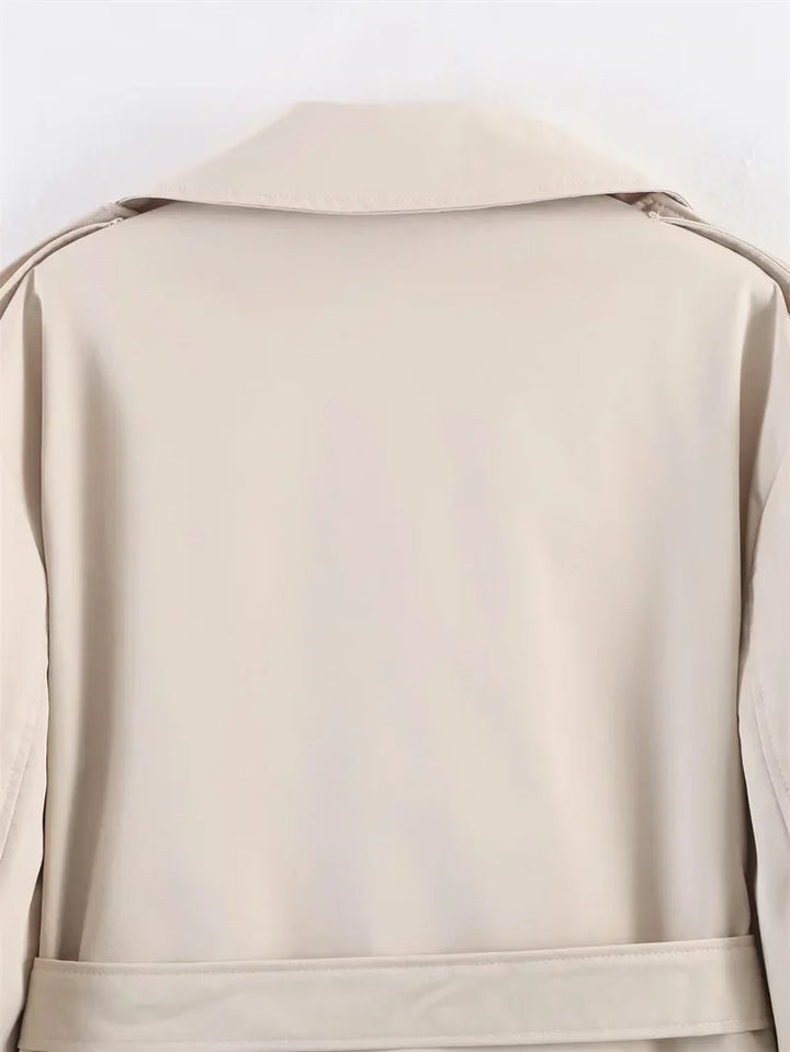 Women's short trench coat, belted for a tailored look, perfect for layering.
