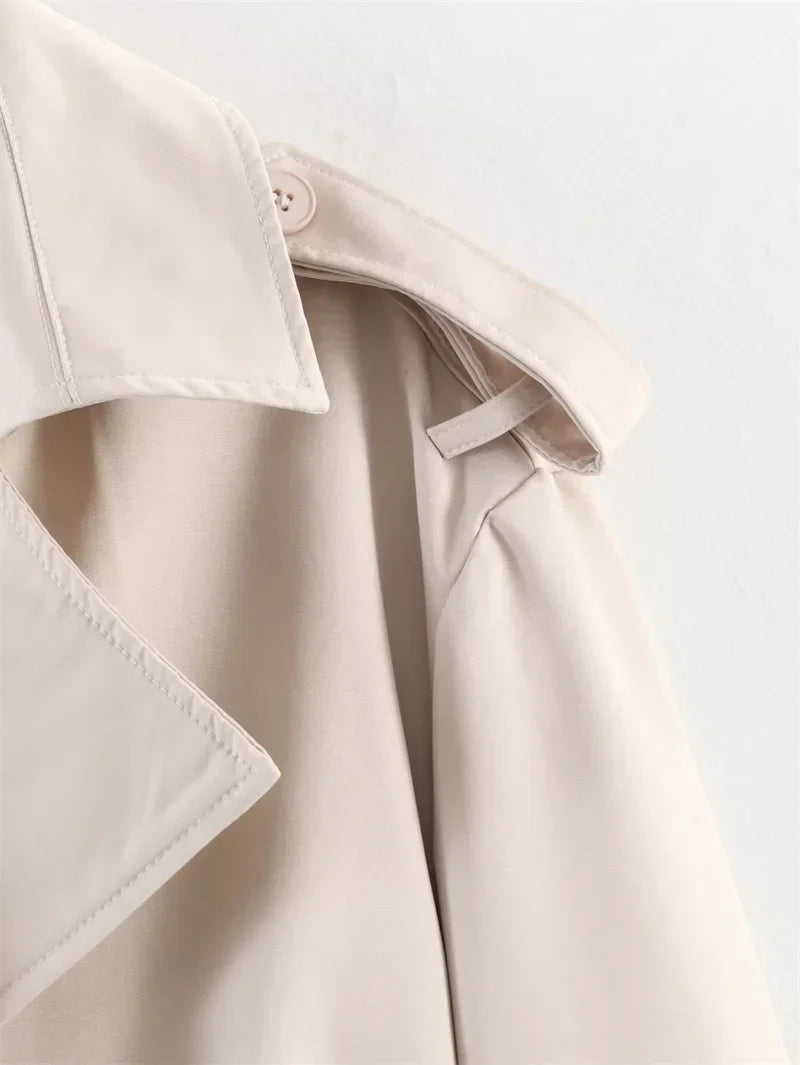 Versatile ladies' short trench with belt, a staple for any transitional wardrobe.