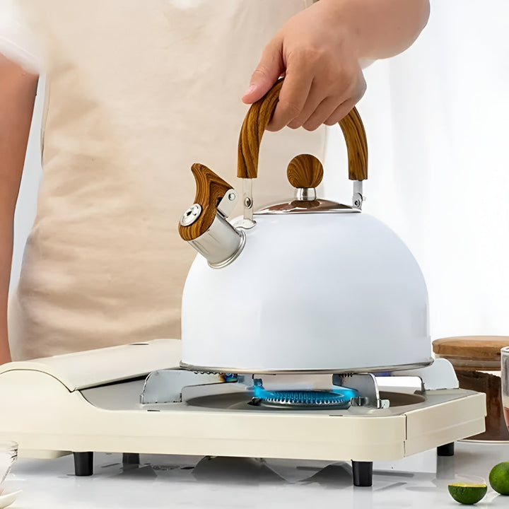 Durable stainless steel whistling tea kettle for stovetops, featuring a comfortable grip for easy pouring & boiling.