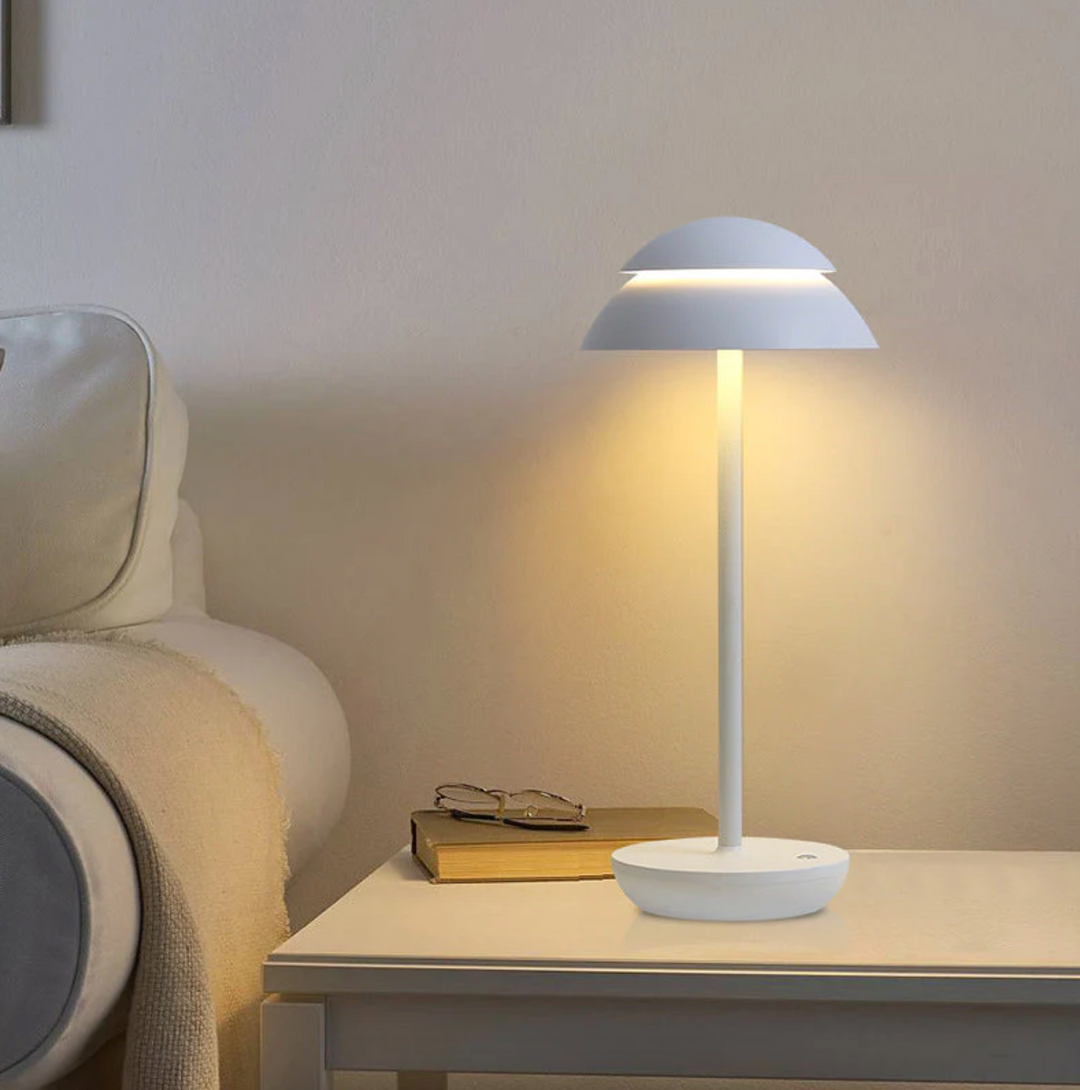 Modern mushroom LED lamp, touch-dimmable, providing soft ambient light for a cozy bedroom or living area.