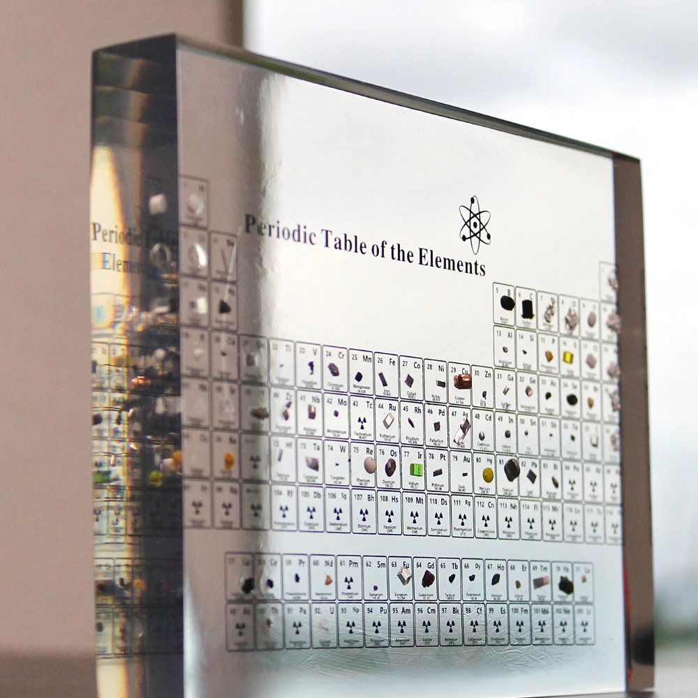 Close-up of illuminated periodic table showcasing various real elements for science education.