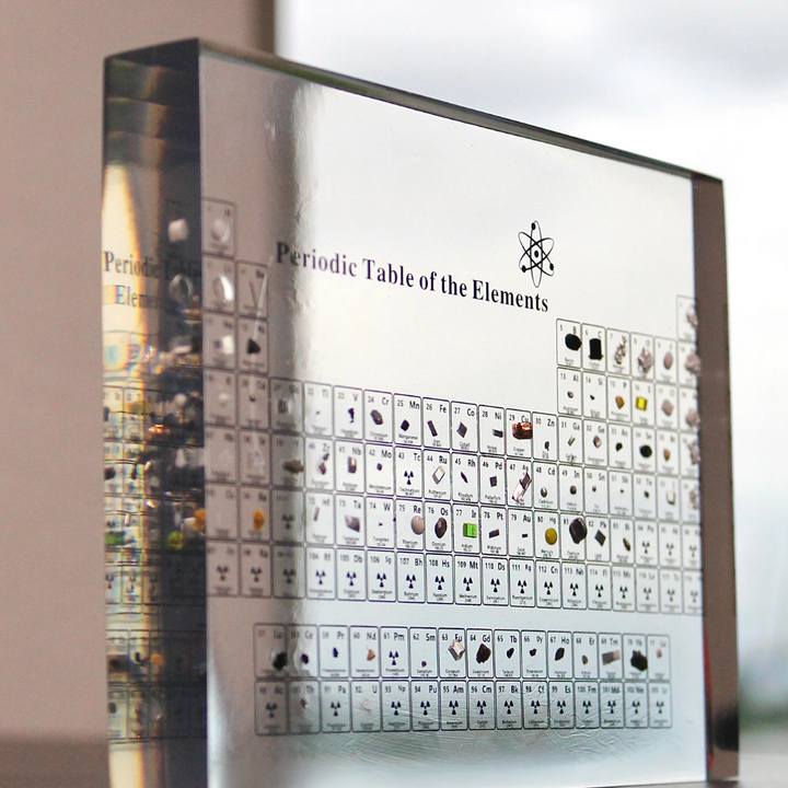 Close-up of illuminated periodic table showcasing various real elements for science education.