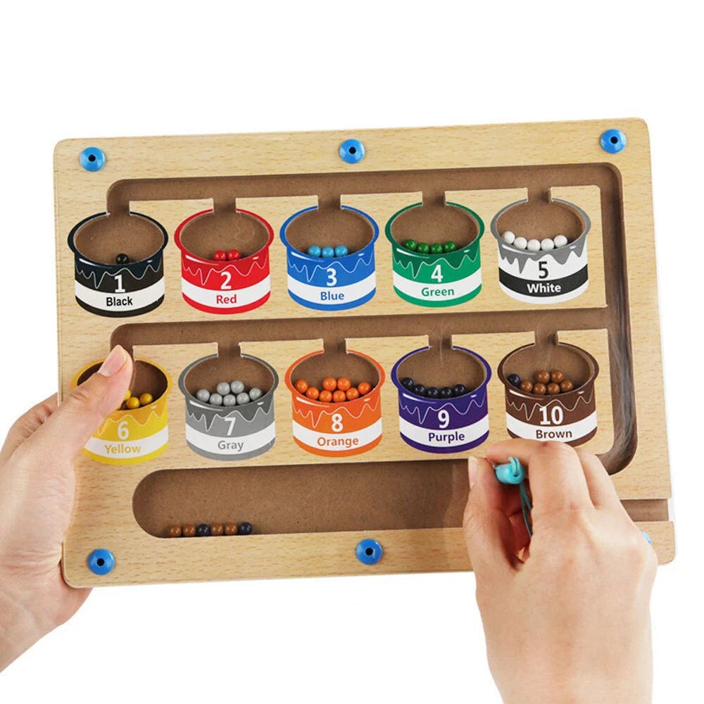 Happy toddler navigating a magnetic maze learning puzzle, improving fine motor skills & problem-solving.