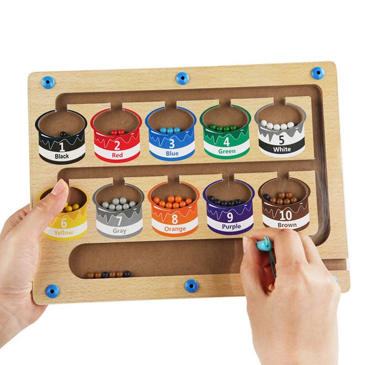 Happy toddler navigating a magnetic maze learning puzzle, improving fine motor skills & problem-solving.