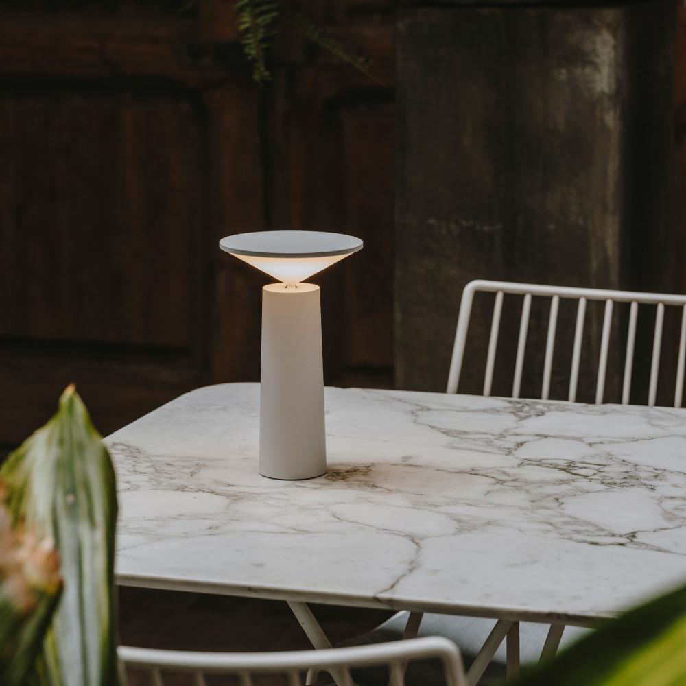 Modern LED table lamp, dimmable & portable, enhancing home decor with adjustable light.