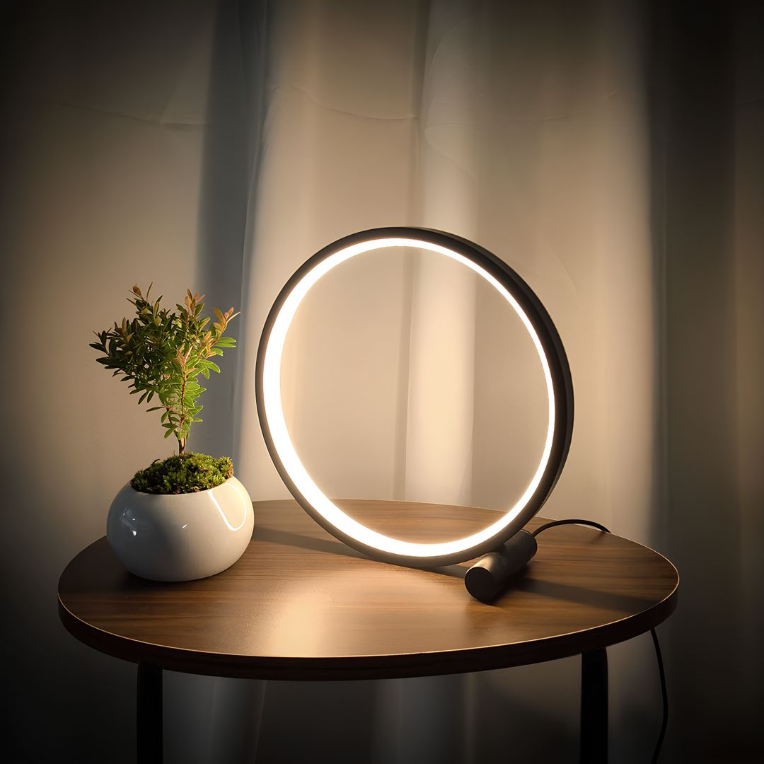 Modern Halo Ring LED lamp for nightstand, dimmable, aluminum finish, perfect bedroom mood lighting.