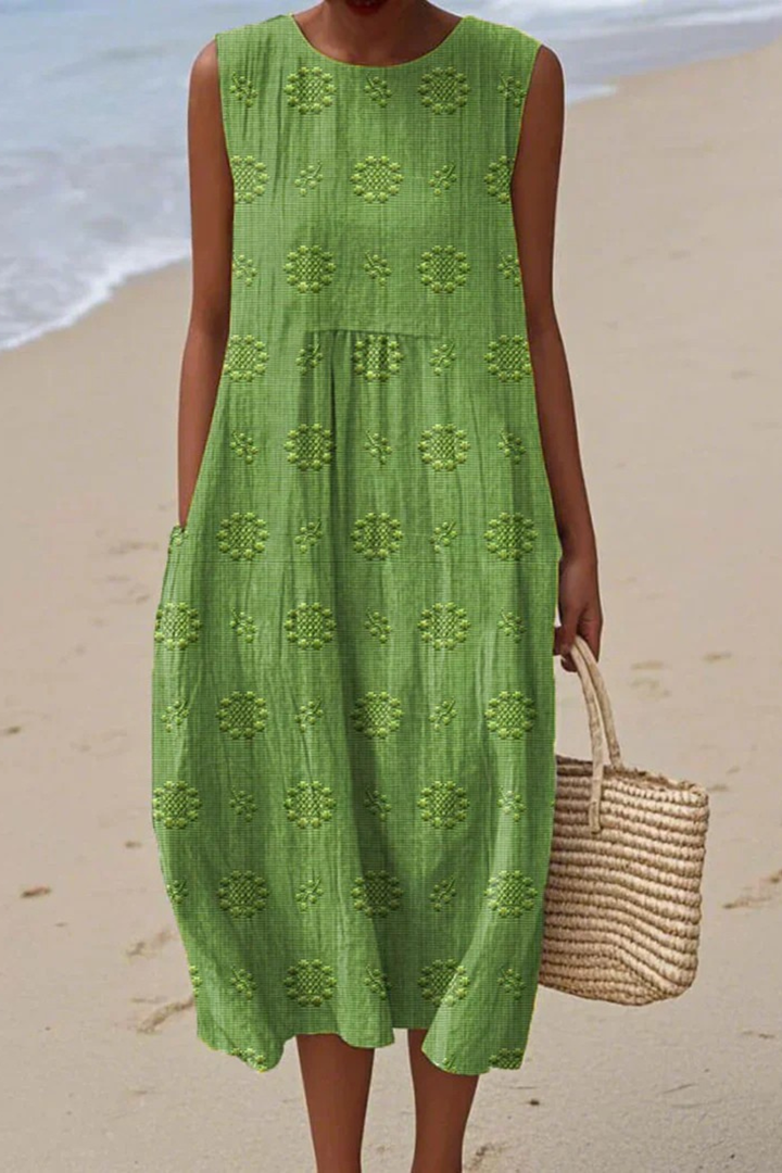 Elegant women's embroidered sleeveless maxi dress, perfect for summer special occasions. Flowing feminine style.