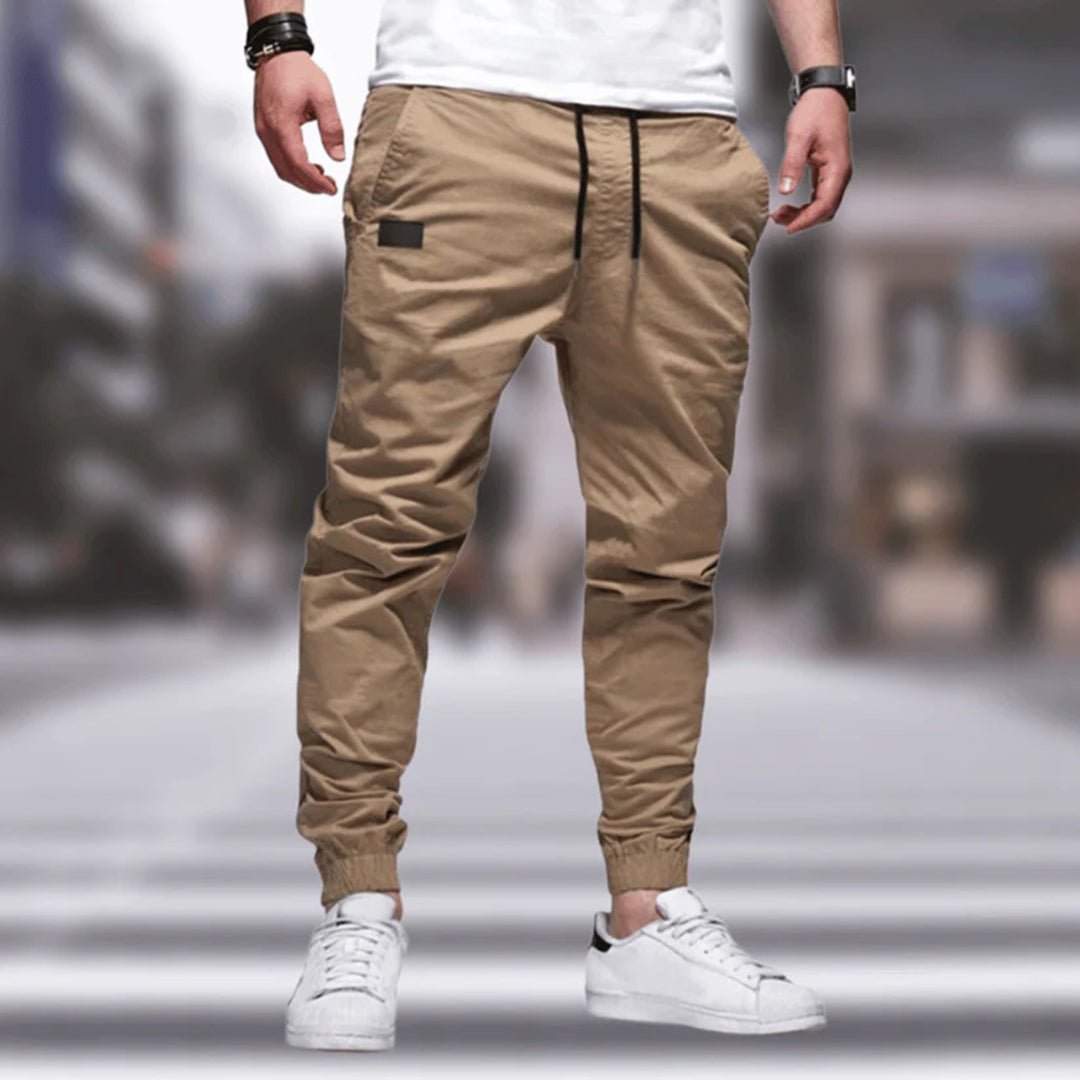 Close-up of men's utility cargo pants showing practical multi-pocket design & durable, comfortable fabric.