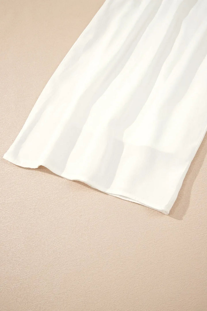 Detail shot: Adjustable drawstring waist on comfortable women's white wide leg pants.