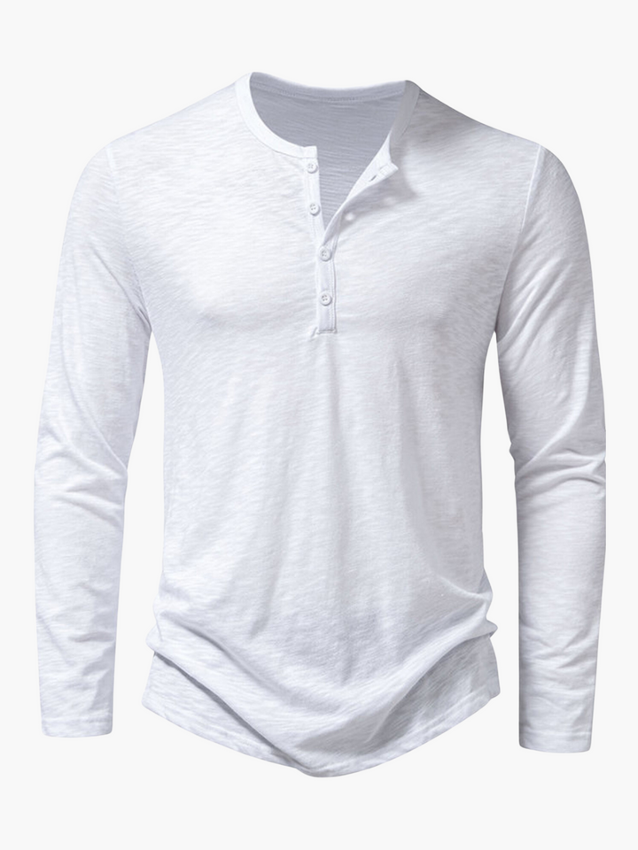 Man in relaxed fit Henley long sleeve t-shirt. Casual button-up top for comfortable everyday men's style & layering.