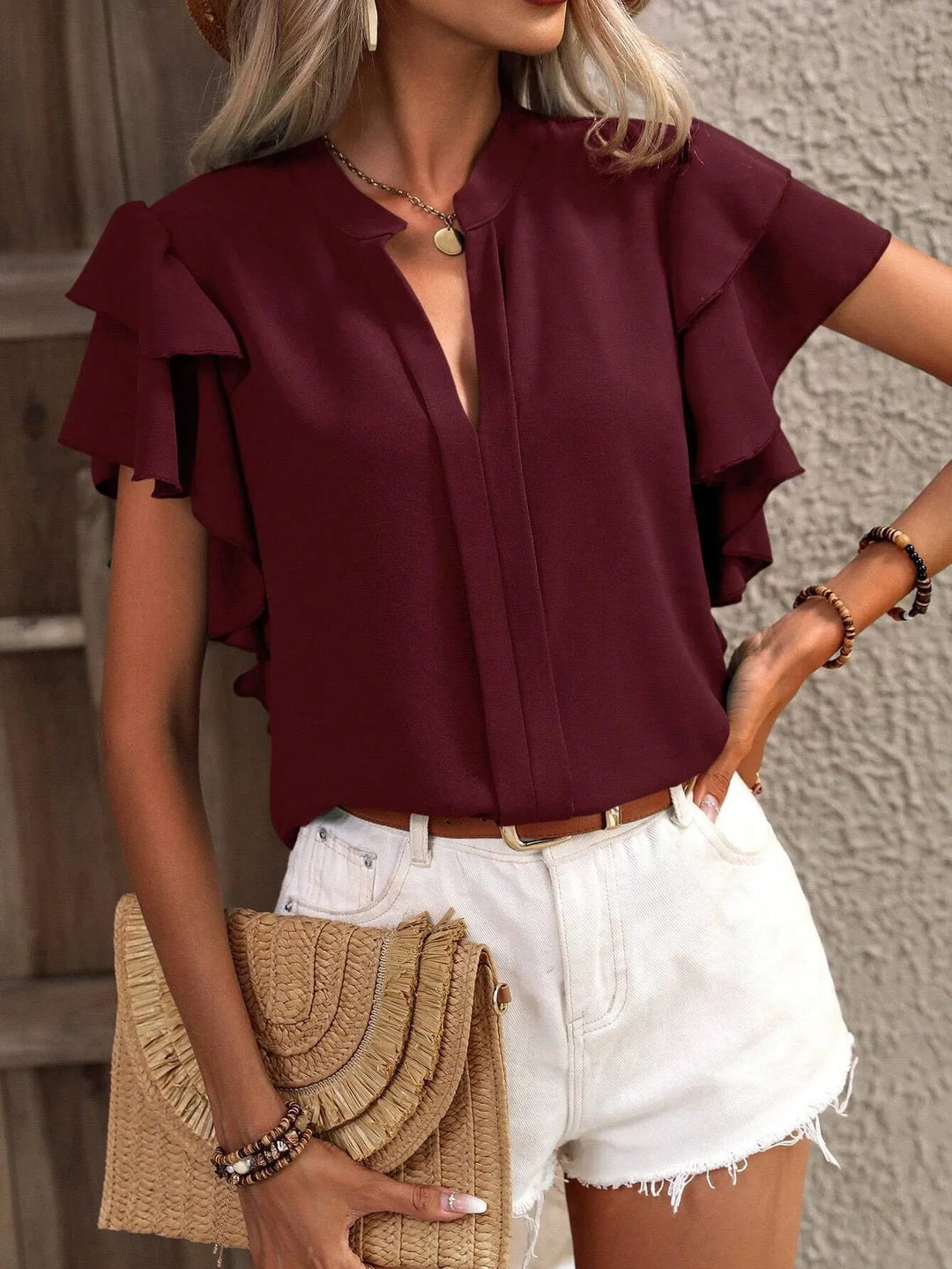 Comfortable women's ruffled short sleeve blouse, ideal for long days, combining style with ease.