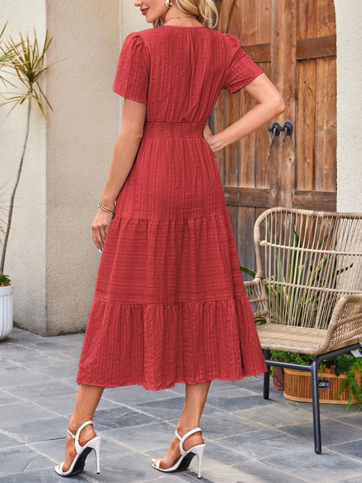 Women's flowy midi dress in motion, highlighting its comfortable, relaxed fit & effortless style.