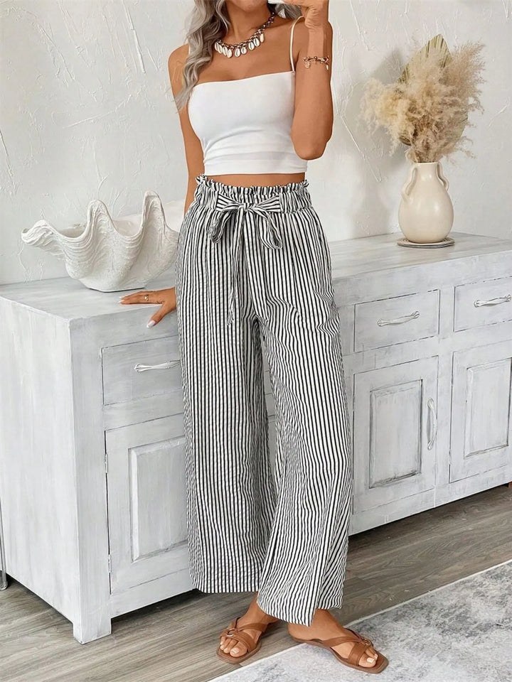 Fashionable women's striped wide leg pants, featuring a stylish paperbag waist.
