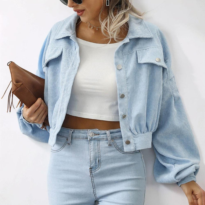 Trendy cropped casual women's jacket featuring a button front closure and fashionable volume sleeves.