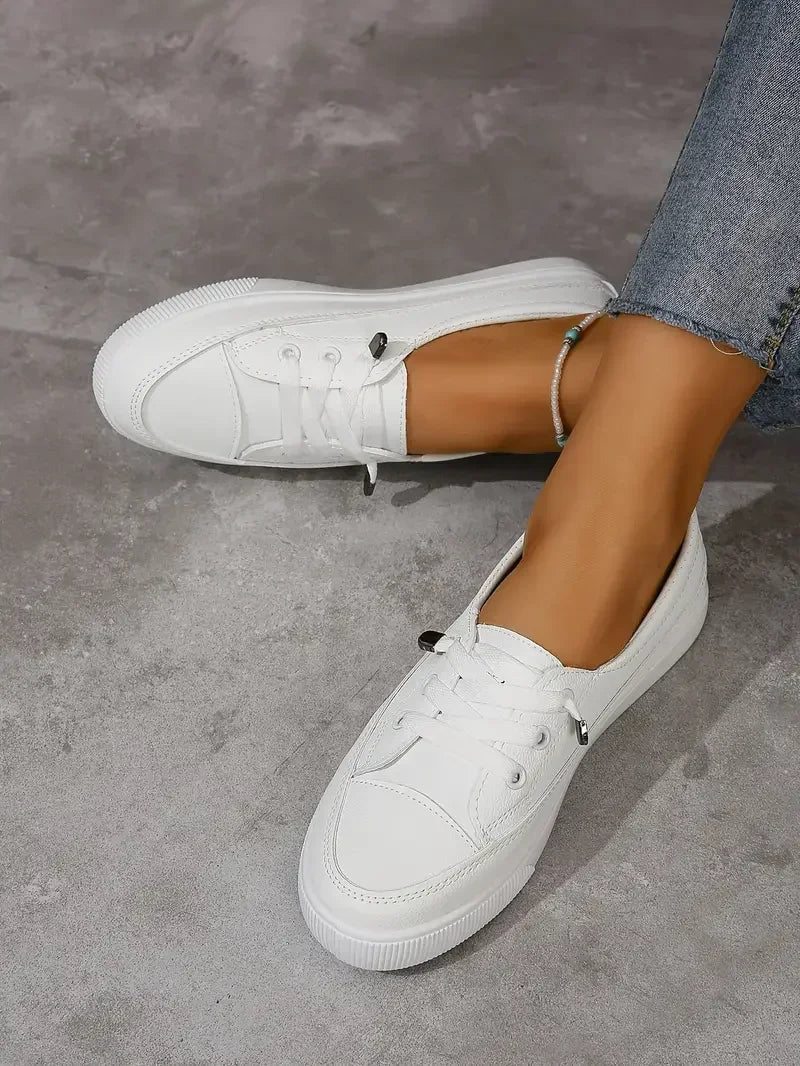White women's casual lace-up flat sneakers with a round toe for everyday comfort.