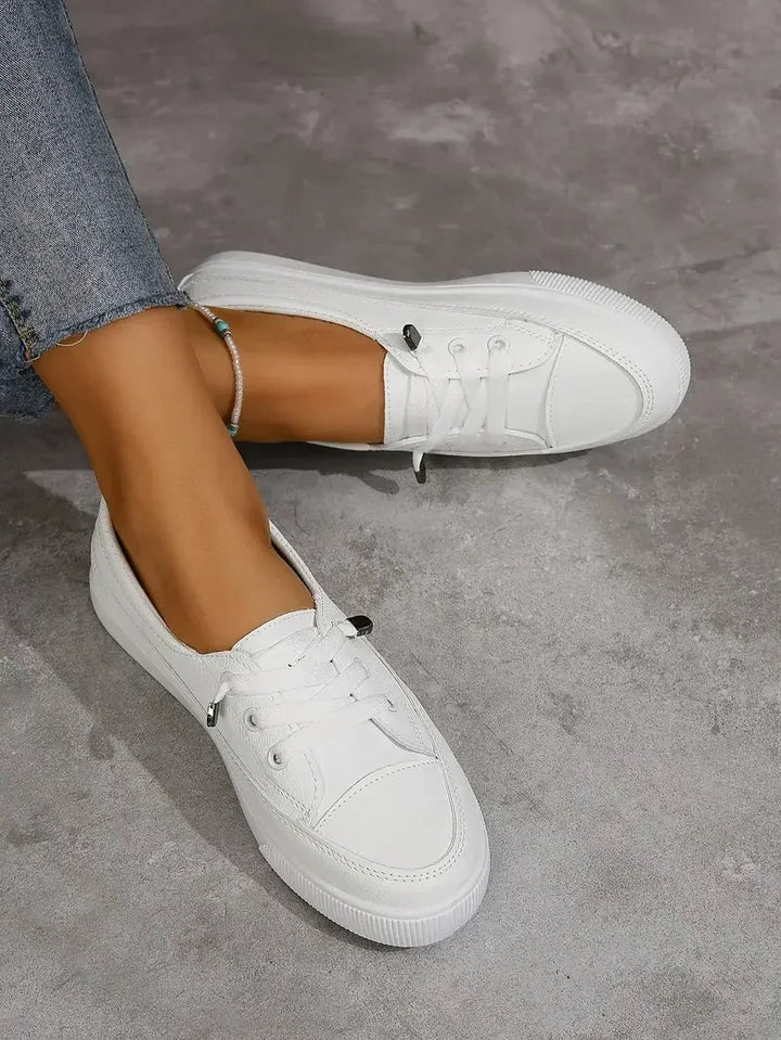 Everyday white women's casual lace-up flat sneakers with a round toe, designed for comfort.