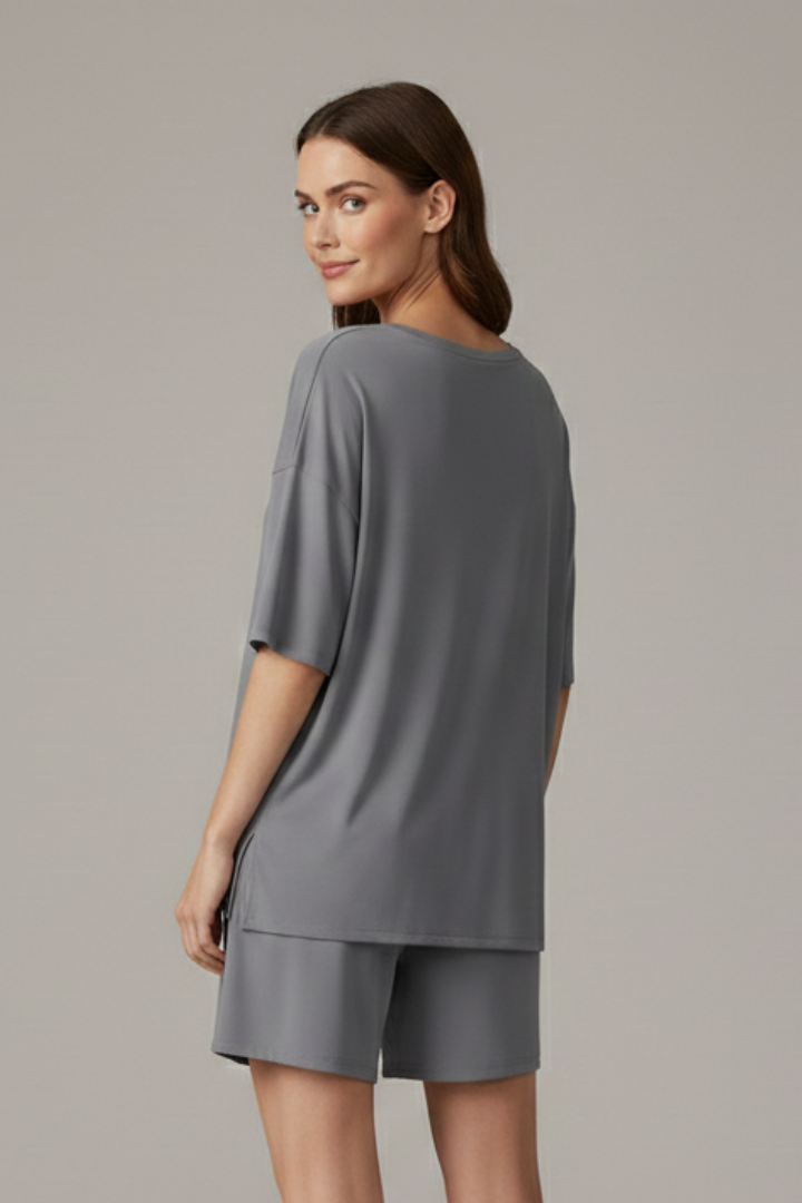 Stylish women's casual two-piece outfit: crew neck top & relaxed loose shorts for summer comfort.