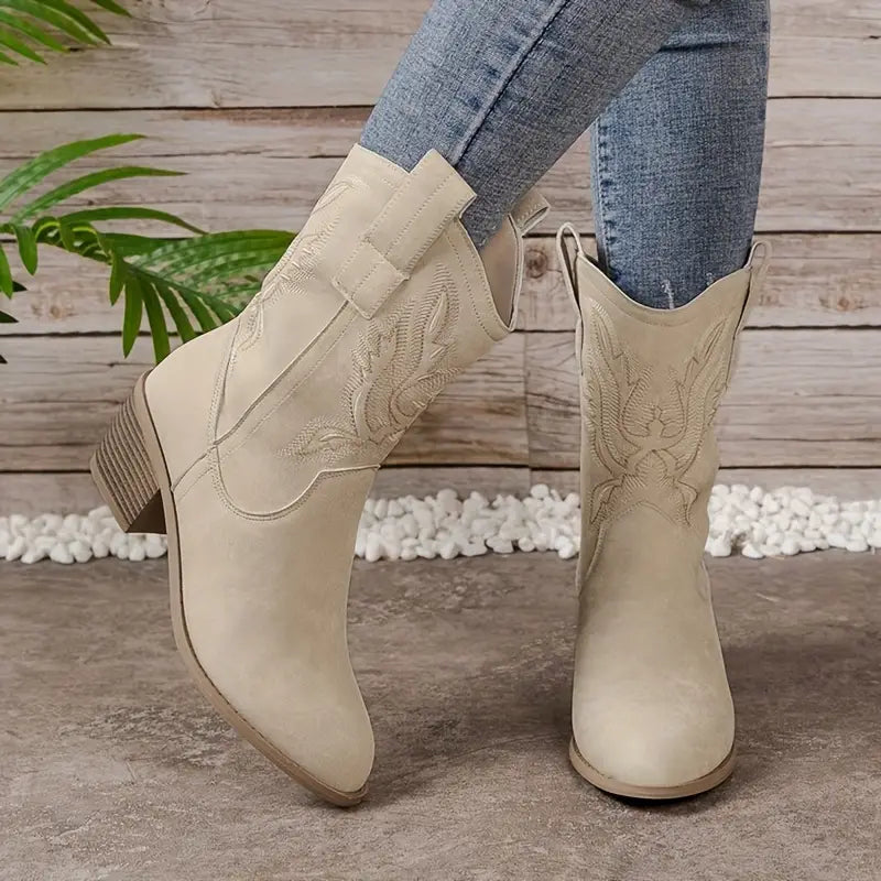 Women's beige mid-calf western boots featuring a sturdy block heel & detailed stitching. Versatile & fashionable cowgirl style.