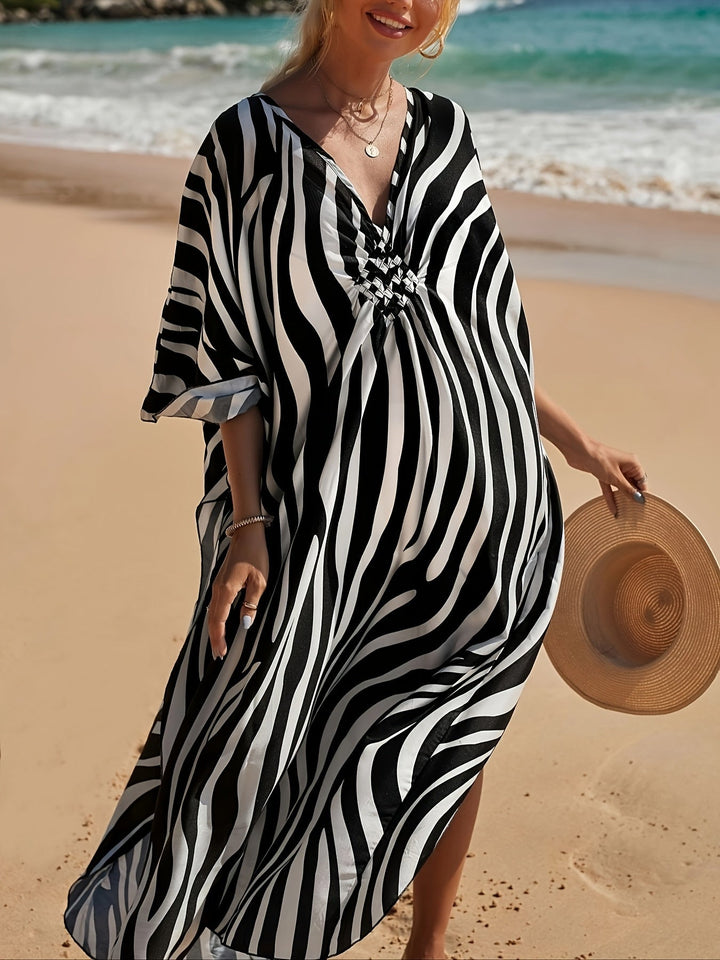 Elegant women's V-neck maxi beach dress in trendy zebra print, great as a summer dress or vacation kaftan.