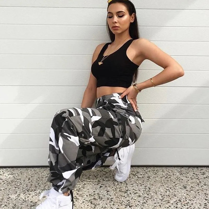 Durable women's camouflage cargo pants, relaxed baggy fit with ankle cuffs. Perfect streetwear fashion.