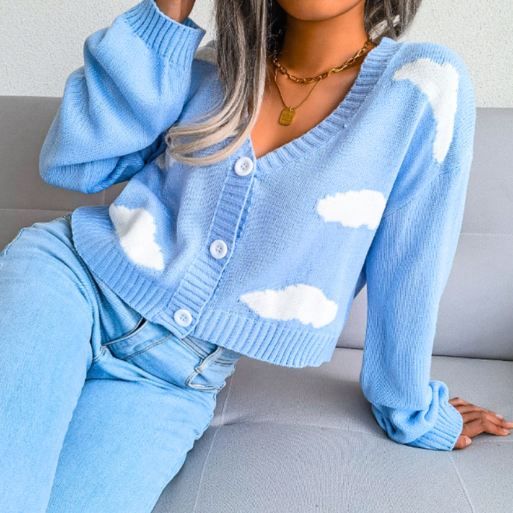 Stylish women's cropped cardigan featuring a dreamy cloud print, V-neck, and button closure. Versatile knitwear.