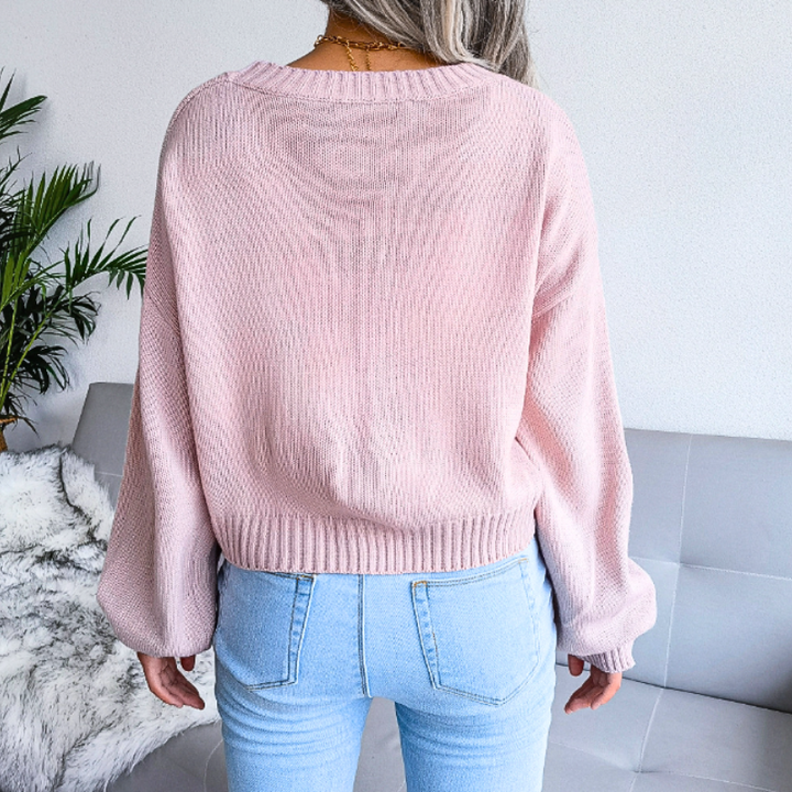 Chic women's cropped V-neck cardigan with a unique cloud print. Button-up knitwear for effortless style.