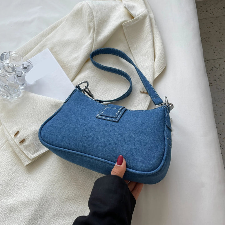 Fashionable women's handbag, a two-way shoulder & crossbody style with a modern buckle closure.