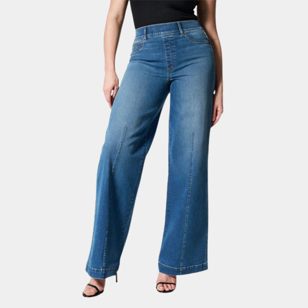 Model wearing dark blue women's high waisted wide leg stretch jeans. Comfortable relaxed fit, perfect for casual wear.