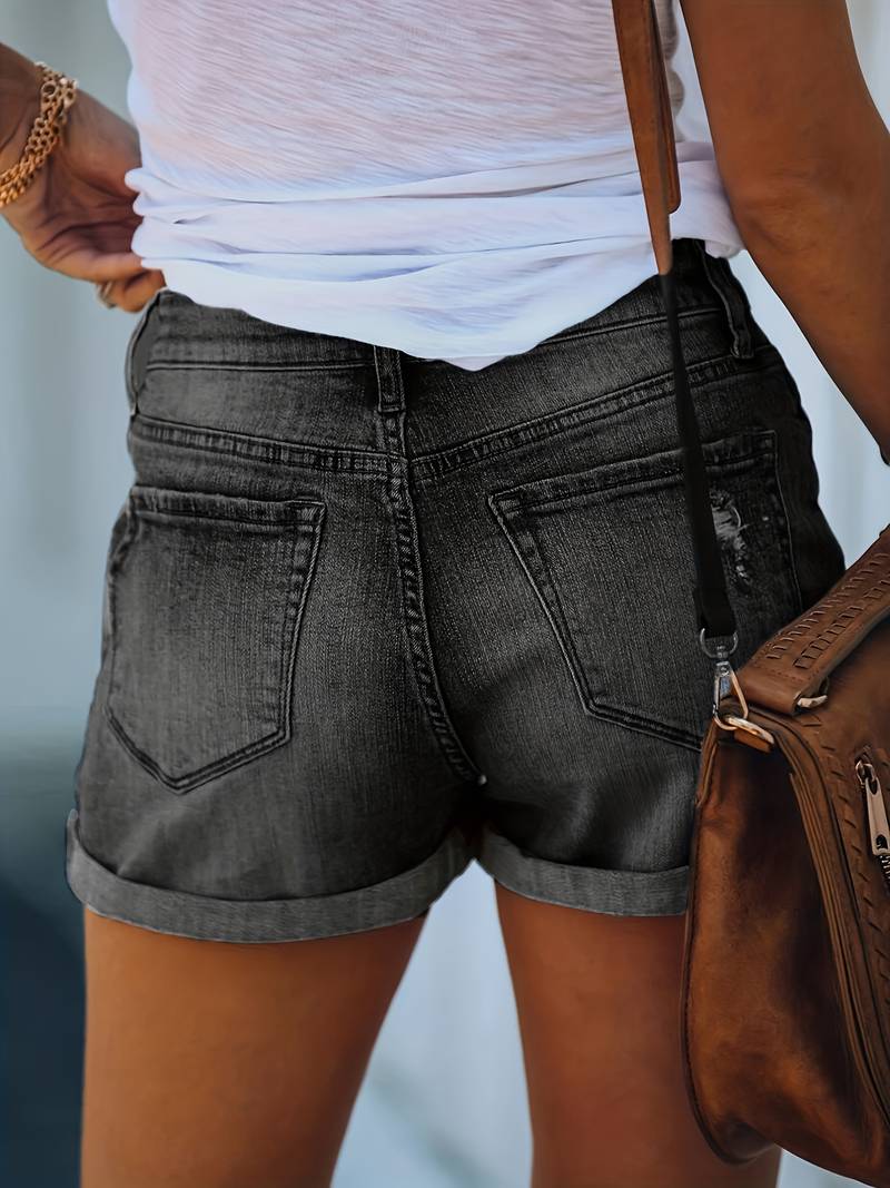 Detailed view of women's double button jorts, highlighting the chic rolled hem and quality denim fabric.