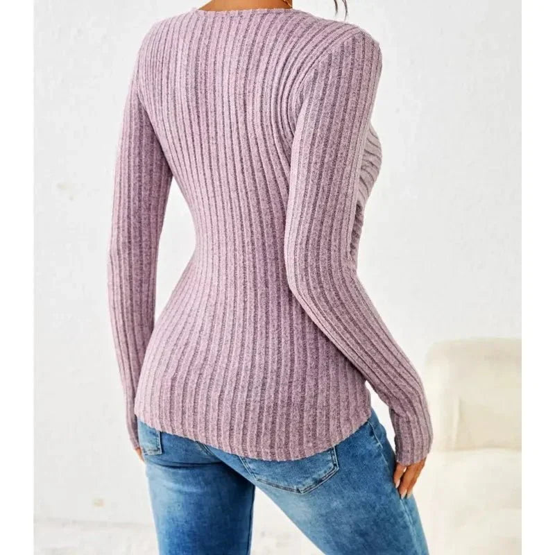 Pink long sleeve ribbed wrap top for women. Features a flattering V-neck and versatile ruched detail.