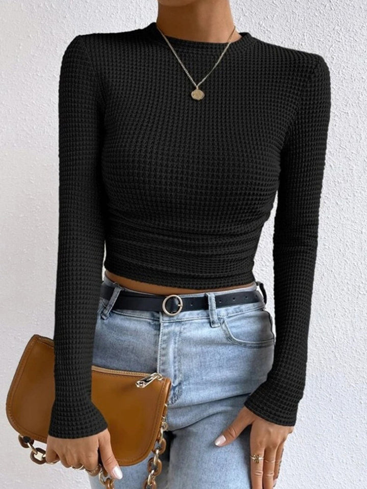 Modern women's waffle textured long sleeve top, crew neck style, a must-have for contemporary fashion.