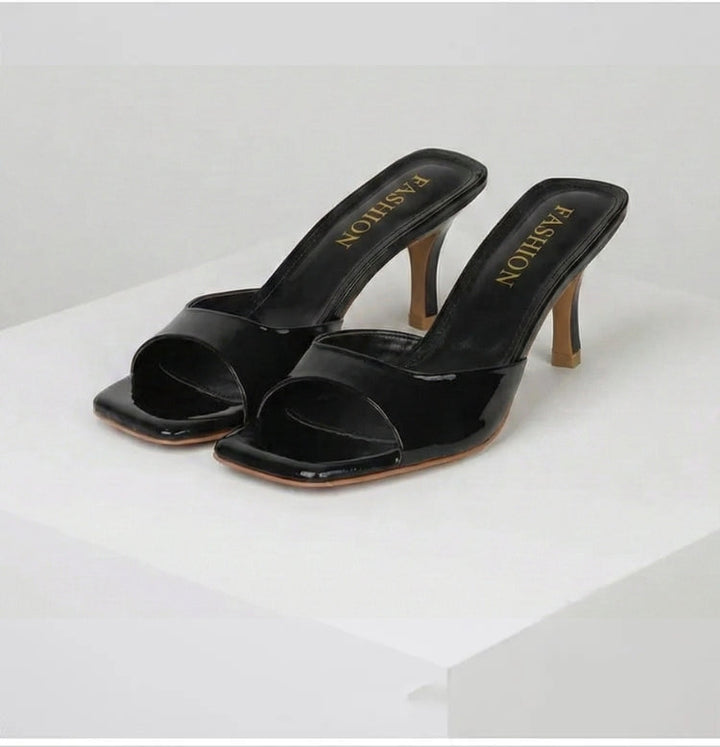 Versatile women's open toe mules. Slip-on design with a stylish square heel. Chic modern footwear.