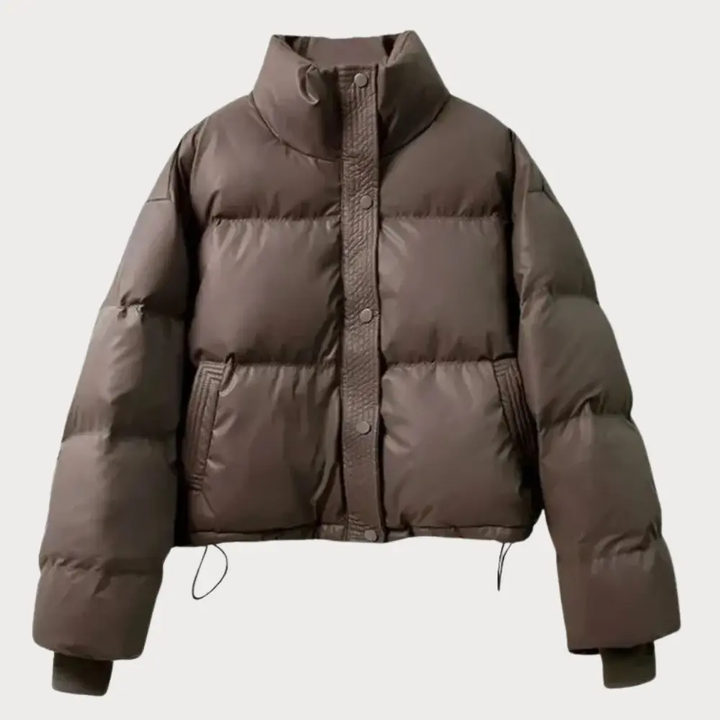 Fashionable women's cropped puffer jacket with secure snap button closure, stand collar, & adjustable hem.